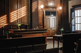 empty courtroom wood paneled, wood furniture, sunlight through window