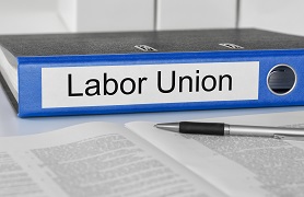 binder labeled labor union with contract and pen