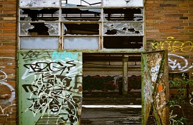 Building with broken windows and graffiti
