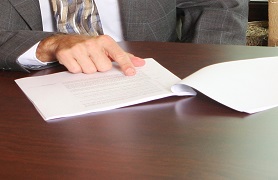 Finger pointing at document.