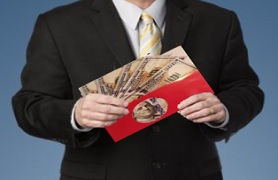 man holding envelope of money